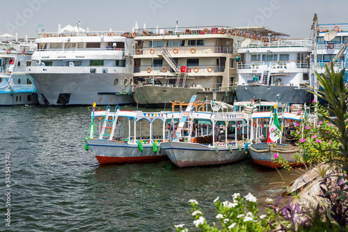 Obraz na plátně Nile river with sailing boats yachts and ferries doing excursions for tourists i