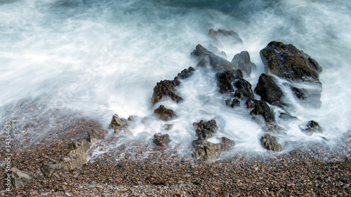 waves breaking on the rocks - long exposure of tidal movement