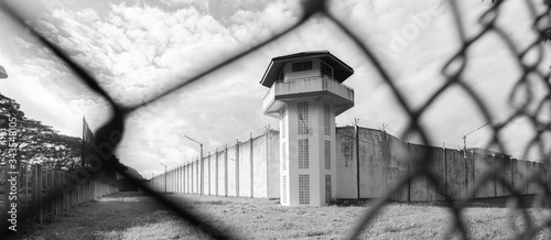 Prison with iron fences.Prison or jail is a building where people are forced to live if their freedom has been taken away.Prison is the building use for punishment prisoner. photo
