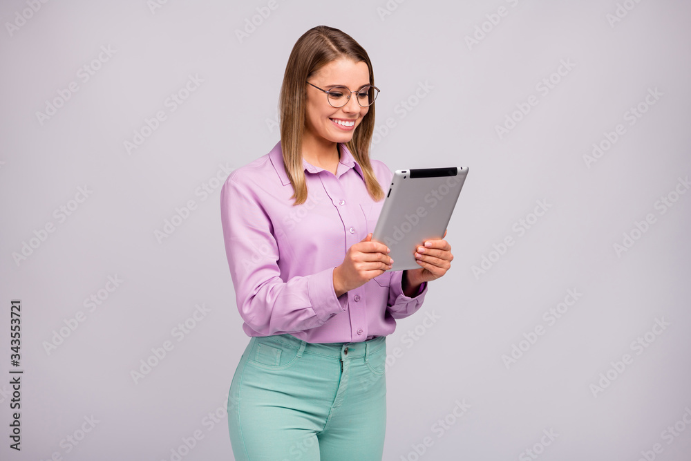 Portrait of positive ceo worker girl use tablet watch workshop seminar have online communication wear good look clothes isolated over gray color background Portrait of positive ceo worker girl use tablet watch workshop seminar have online communication wear good look clothes isolated over gray color background