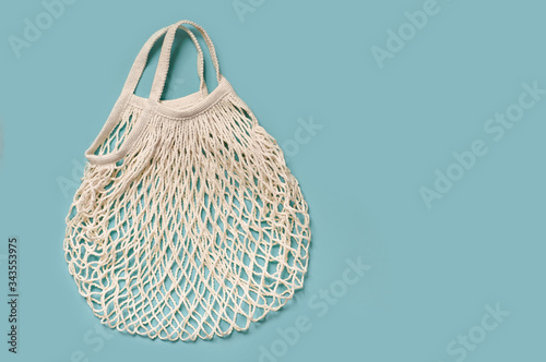 white string bag on a blue background, copy space