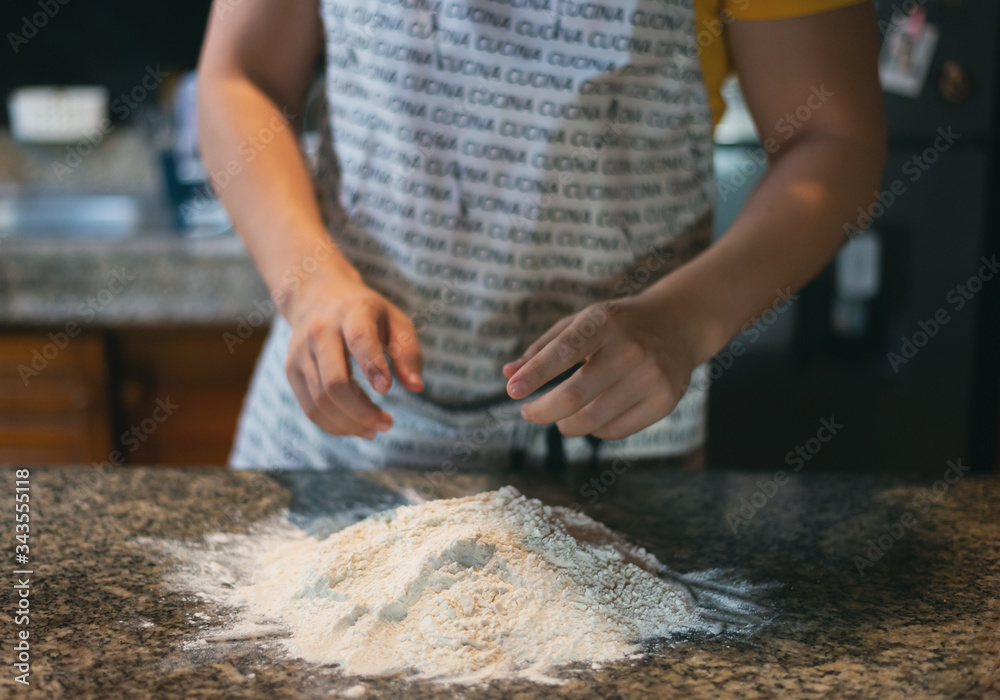 hands ready to prepare dough, flour on the table in rustic kitchen