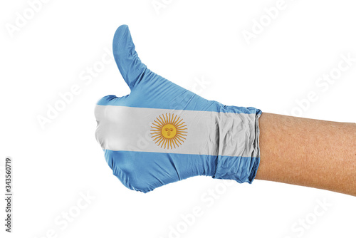 Argentina flag on a hand glove showing thumbs up sign photo