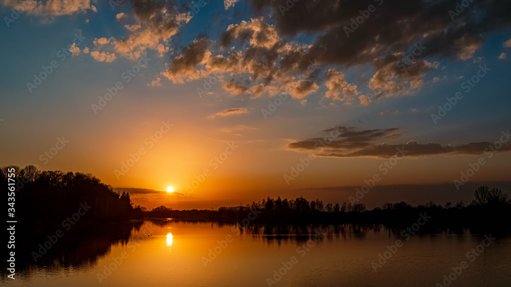 Beautiful sunset with reflections near Ettling, Isar, Bavaria, Germany