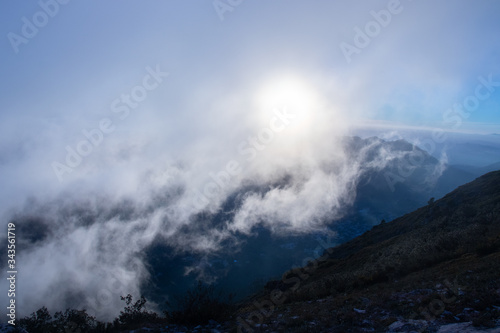 Beautiful clouds above the mountain with the sun in the background