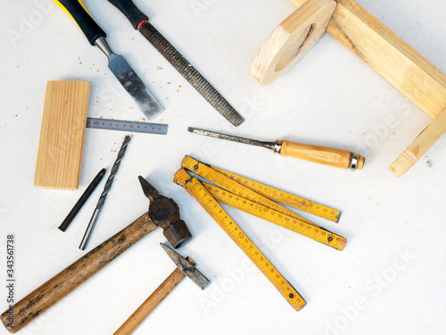 carpentry tools, hammer, chisel, tape measure, drill, scraper