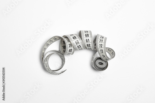 White measuring tape on white background.Mock-up.High-resolution photo. photo