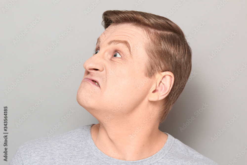 Obraz premium Portrait of blond mature man with angry annoyed expression