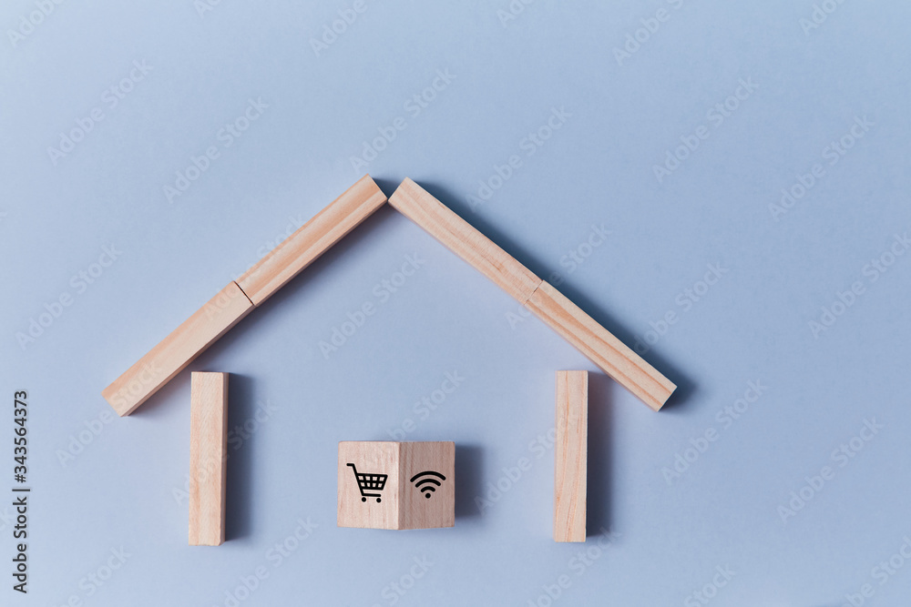 Online shopping. Order on-line. E-commerce. Internet store, supermarket. House and wooden cube with trolley, wifi signs Online shopping. Order on-line. E-commerce. Internet store, supermarket. House and wooden cube with trolley, wifi signs