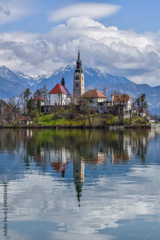 Lake Bled in spring with the Alps with snow in the background
