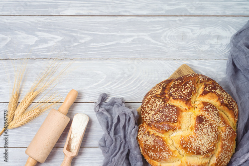 Homemade challah bread on wooden table. Top view from above