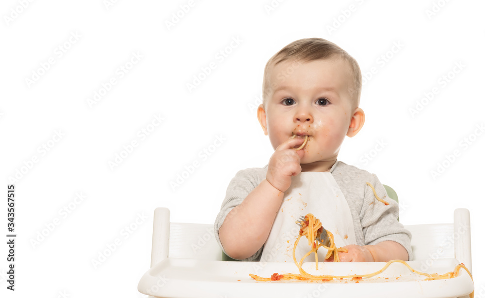 Portrait of funny baby boy that eats spaghetti in tomato sauce on white isolated background. Portrait of funny baby boy that eats spaghetti in tomato sauce on white isolated background.