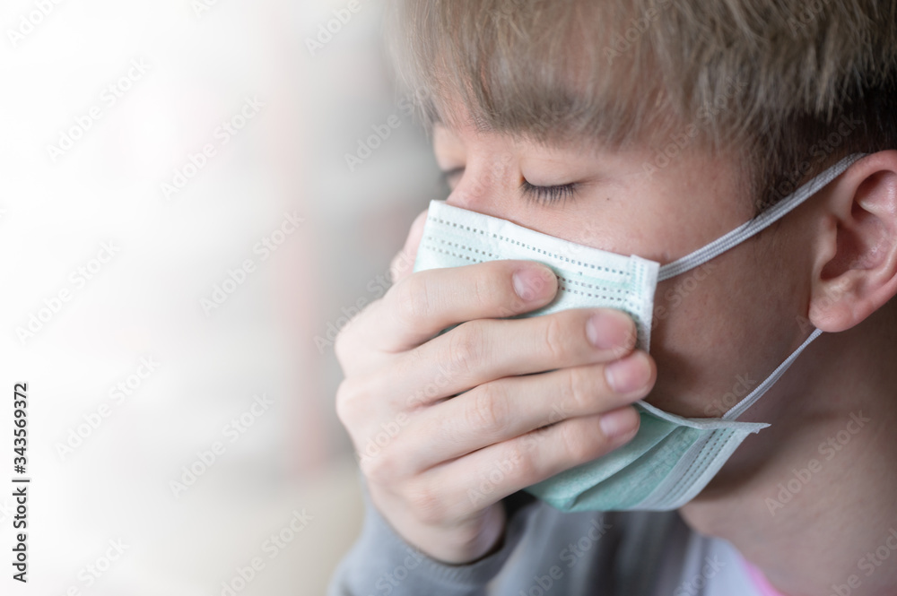 Young asian man wearing medical face mask with coughing on white background