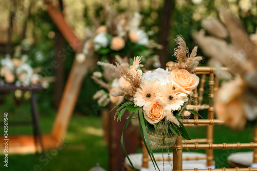 Decoration of the flower arrangement  for the wedding ceremony in the green forest .