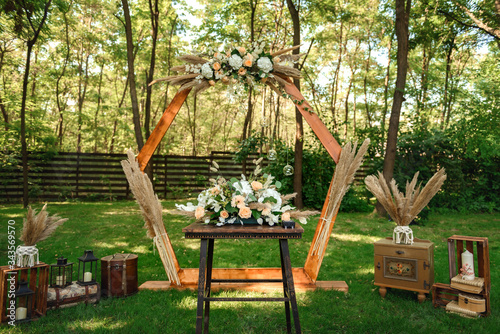 Decoration of the flower arrangement  for the wedding ceremony in the green forest .