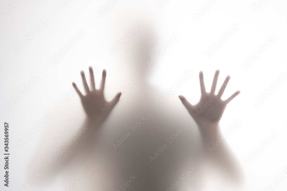 unidentified person behind blur screen touching with two hands