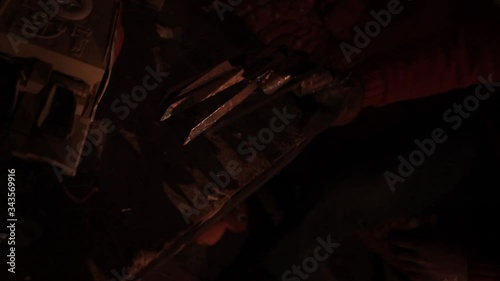 portrait of a man with a scary face and metal claws. Grimm hero for a horror movie. Freddy Krueger.