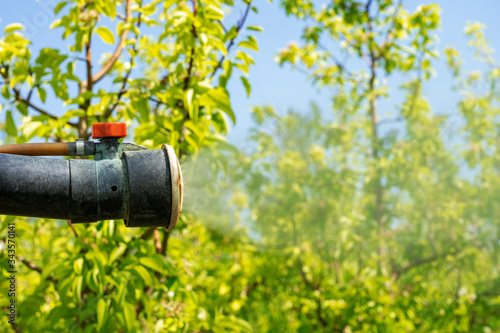 Atomizing Spray Nozzel Spraying Orchard - Close Up Shot photo