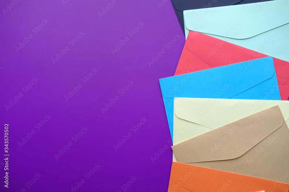 high angle view of colorful envelopes purple background high angle view of colorful envelopes purple background