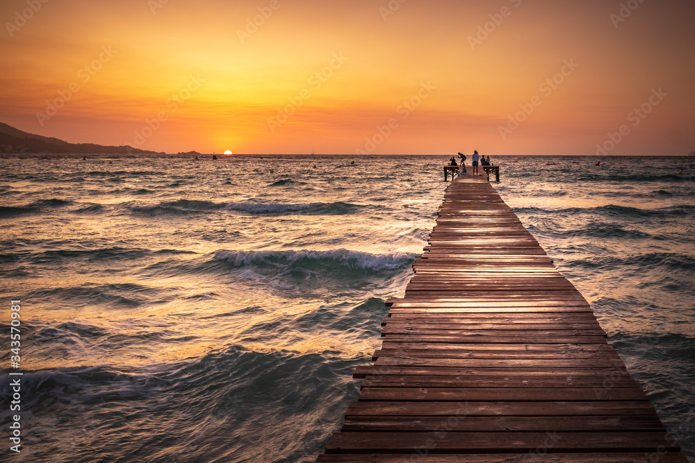 A wooden pier at Playa de Muro beach in Mallorca