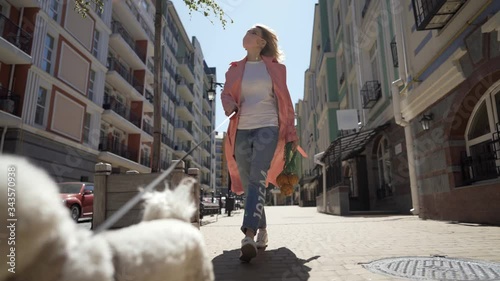 Girl walking outdoors with dog during pandemic of COVID-19