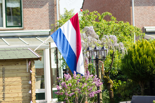 Dutch flag a garden during a national holiday in the Netherlands