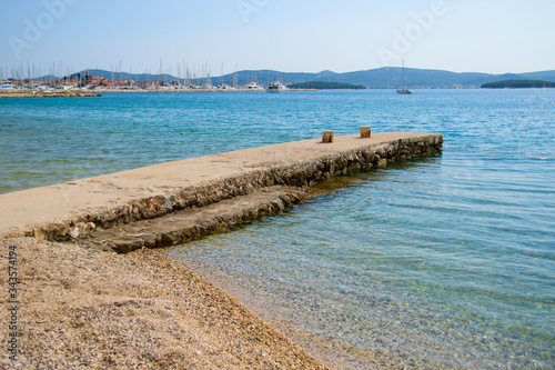 Stone jetty with turquoise waters in the Adriatic Sea on the Croatian coast