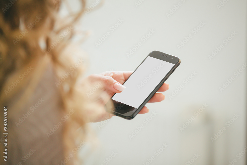 Woman with modern mobile phone in hands
