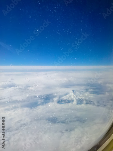 Solid clouds during the flight. View from the window of the plane at high altitude © Tatiana Nikitina