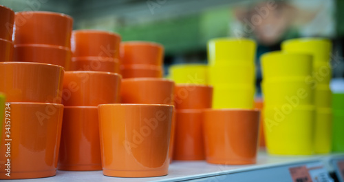 Orange and yellow flower pots on the counter in the store