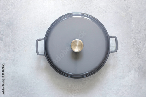 Принти на полотні An empty cast-iron pot on a gray concrete background.
