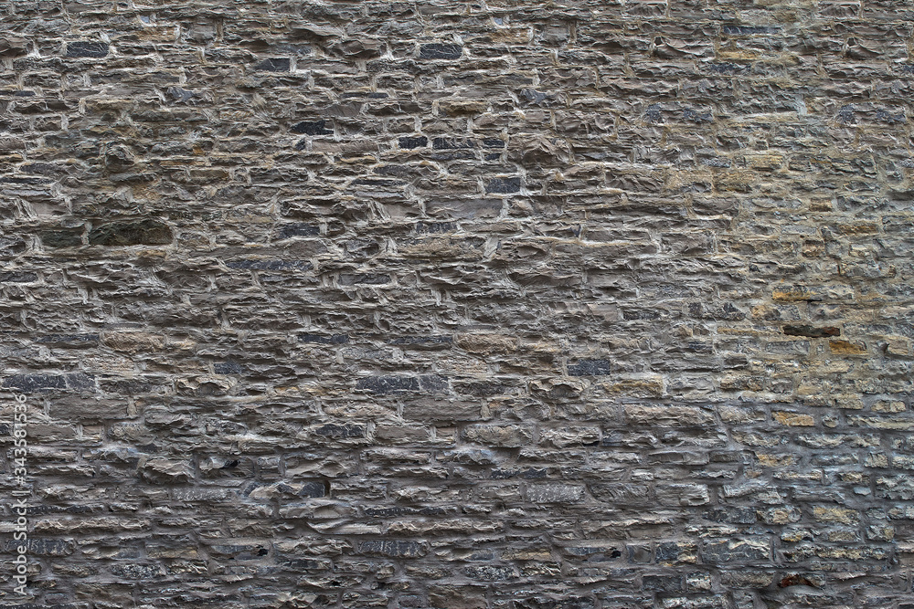 Texture of a stone wall. Old castle stone wall background. Wall made of wild stone. Natural background Texture of a stone wall. Old castle stone wall background. Wall made of wild stone. Natural background