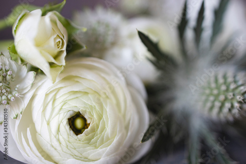 White flowers close up with roses and thistle.
