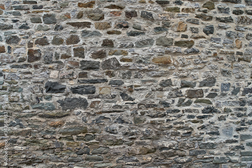 Texture of a stone wall. Old castle stone wall background. Wall made of wild stone. Natural background