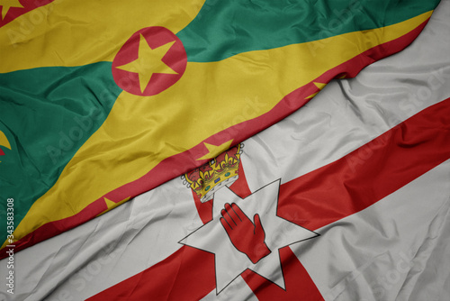 waving colorful flag of northern ireland and national flag of grenada.