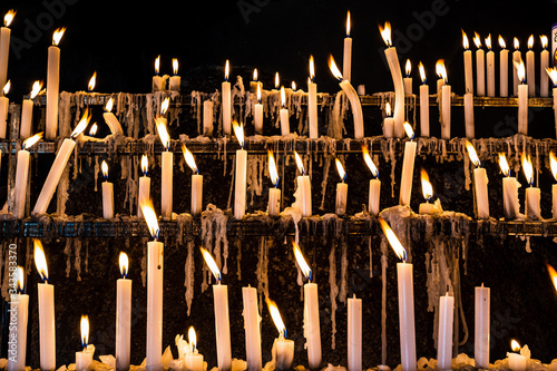 Fotografie hundreds of candles at a wake, lit by religious looking for graces and promises