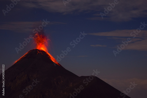 Vulcanic Eruption at night, with Lava flwoing donwn the cone of Volcan del Fuego on Volcan Acatenango