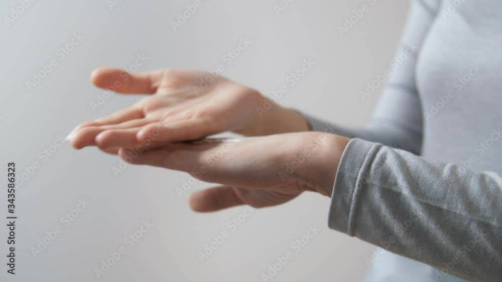 people, cosmetics and bodycare concept - close up of woman applying moisturizing hand cream people, cosmetics and bodycare concept - close up of woman applying moisturizing hand cream