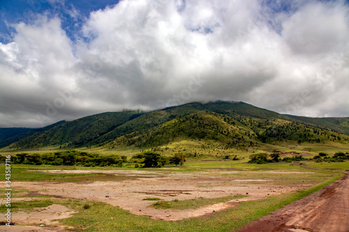 Ngorongoro valley with mountains in the background on a cloudy day, Tanzania, Africa