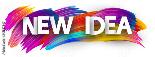 Big new idea sign over brush strokes background.
