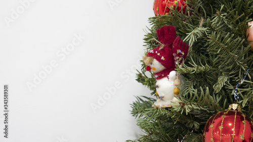 Christmas tree with snowman and red balls. White background