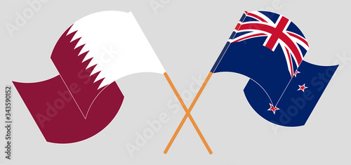 Crossed and waving flags of New Zealand and Qatar