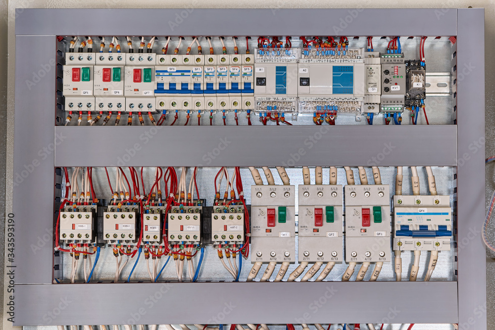 Motor protection circuit breakers, remote access controller, phase and voltage control relays, thermostat and contactors with front additional contacts in the electrical Cabinet.