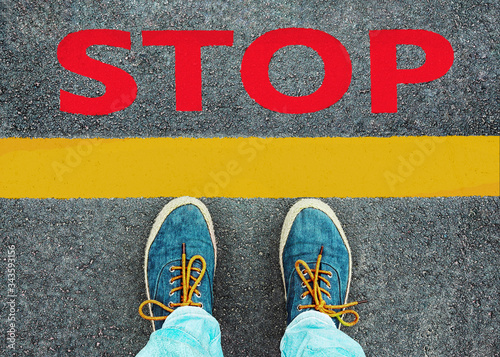 Women's feet in sneakers stand at the line with the inscription 