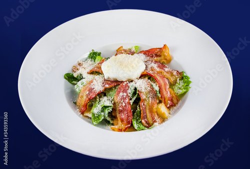 Salad with fragrant breadcrumbs, bacon, parmesan and fresh leaves lettuce, dressed with soft cheese