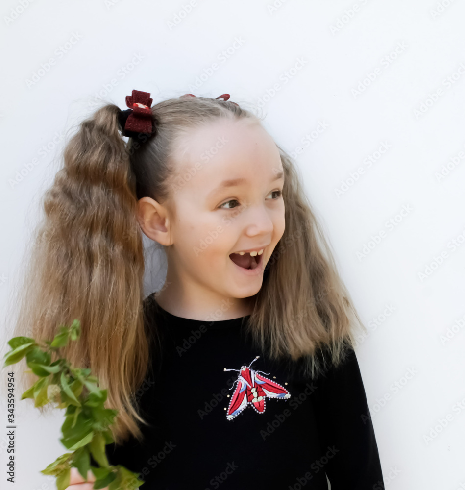 little girl rejoices delighted on a white background little girl rejoices delighted on a white background