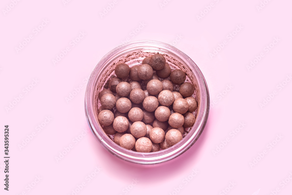 Close up of face powder pearls in an open powder box. Close up of face powder pearls in an open powder box.