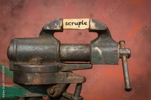 Vice grip tool squeezing a plank with the word scruple