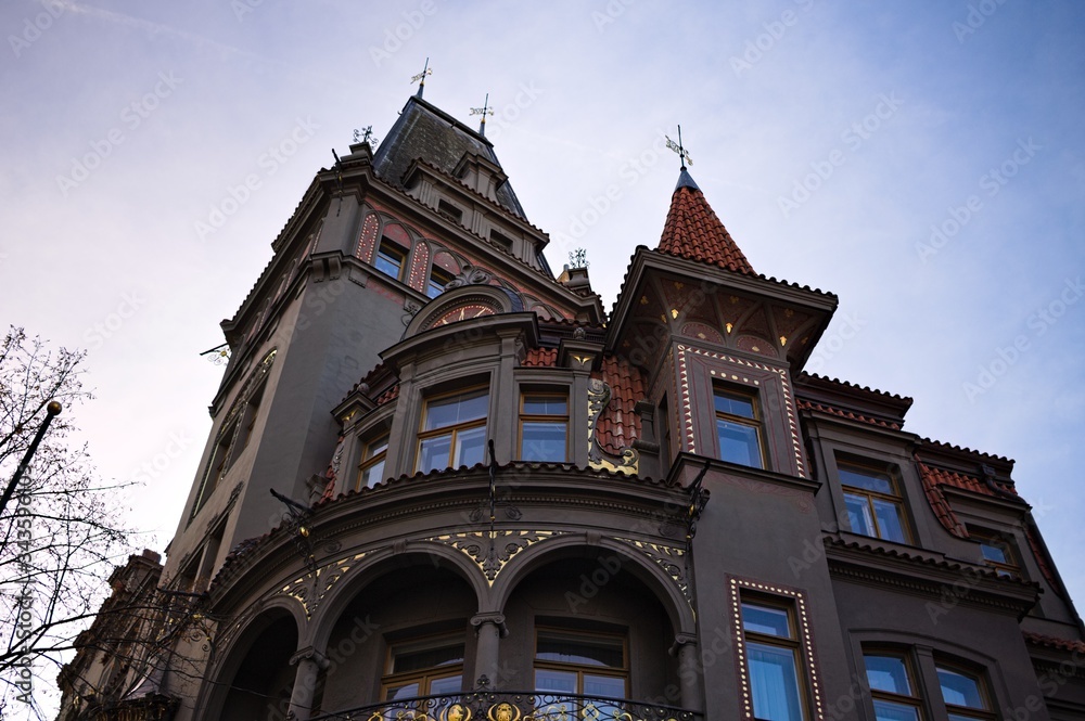 Old bohemian building with towers, spires and decorations (Prague, Czech Republic, Europe)