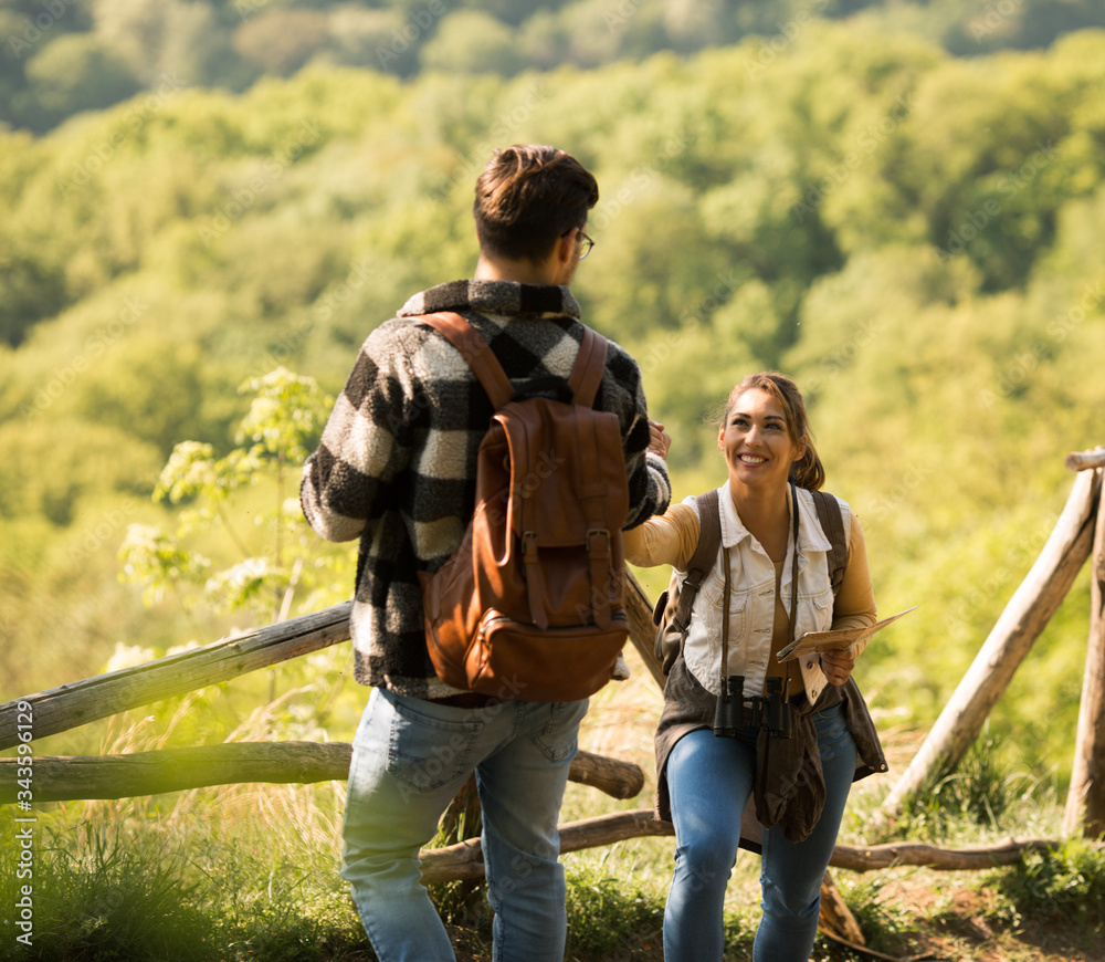 Hiker couple looking at eachother in happiness Hiker couple looking at eachother in happiness
